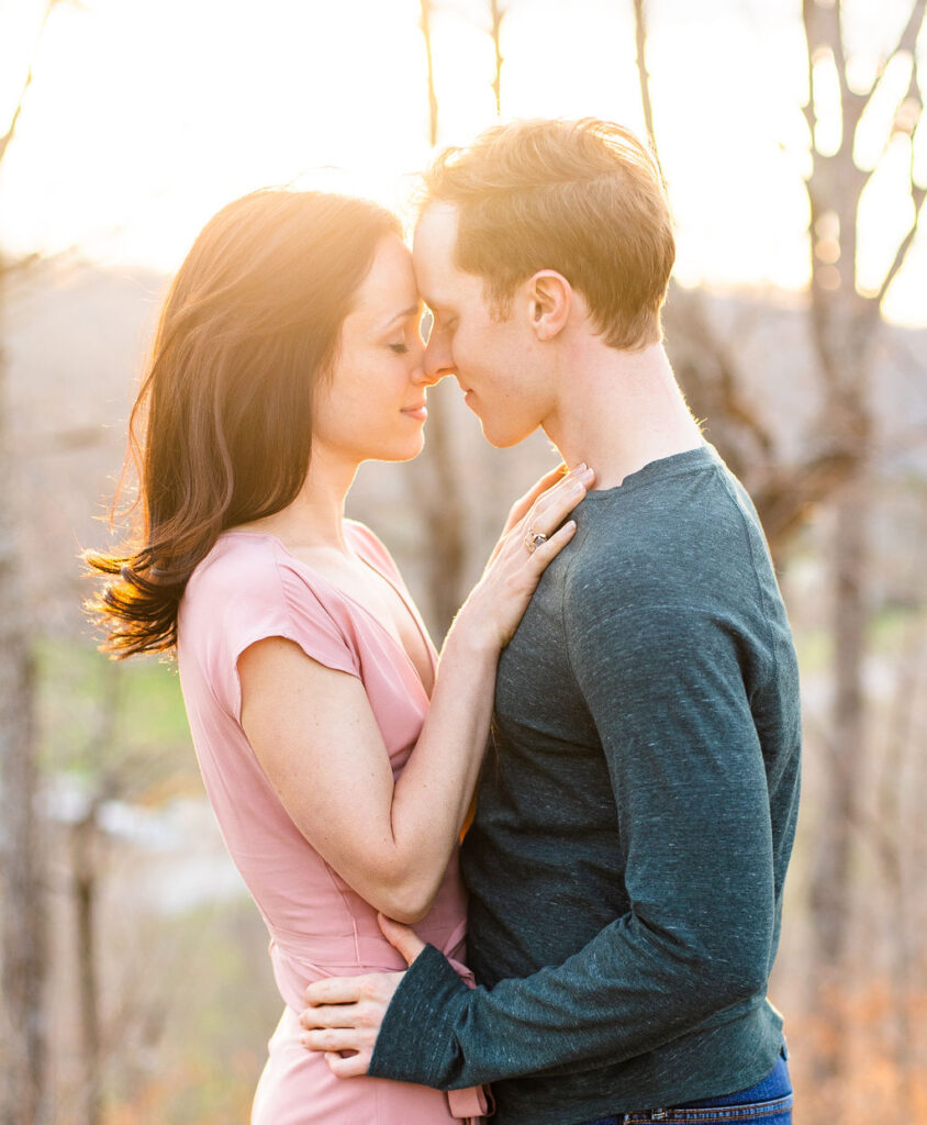 Girl and guy forehead to forehead during the golden hour moment of their engagement session