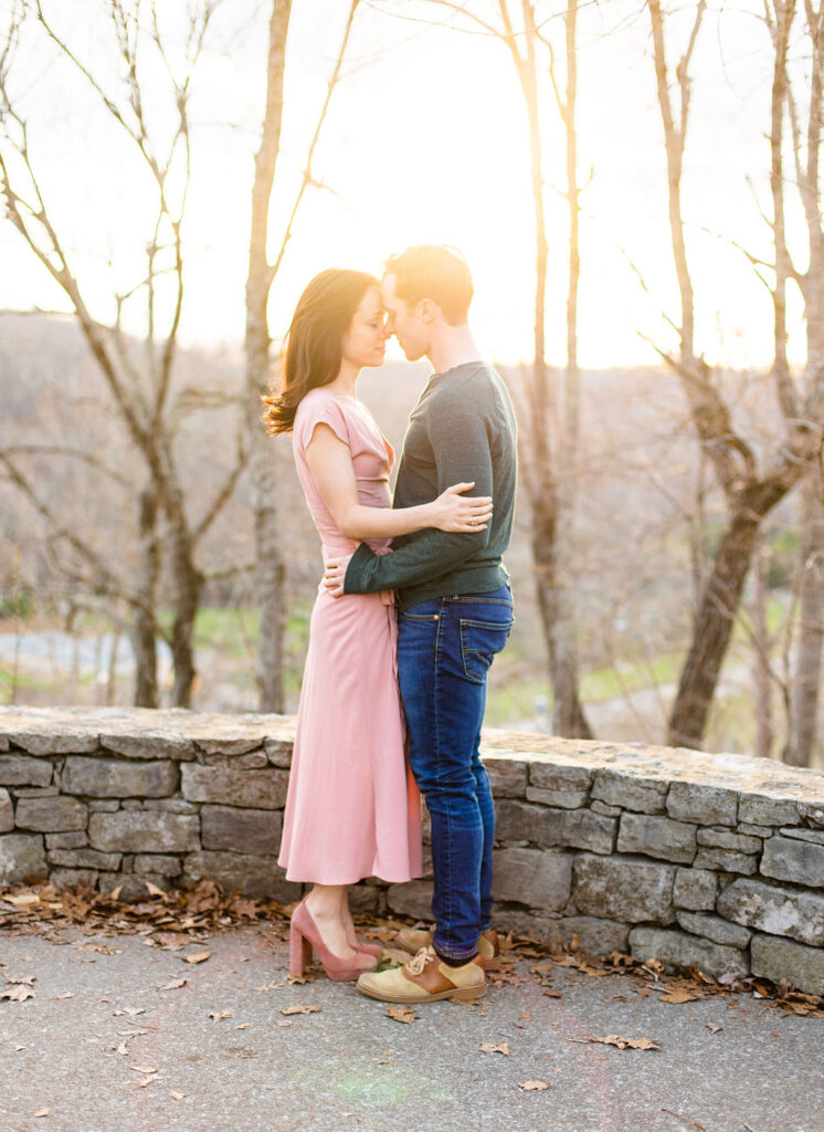 Guy and Girl in a classic engagement pose of chest to chest with foreheads touching