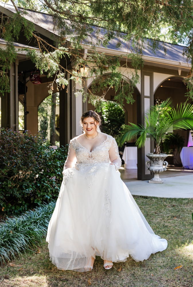 Bride beaming with joy as she walks across the beautiful grounds at Annabella at Cedar Glen in Huntsville, Alabama.