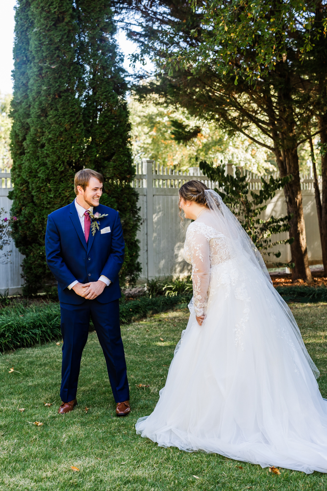 Bride and groom smiling and laughing as they see each other for the first time on their wedding day in Huntsville, AL.