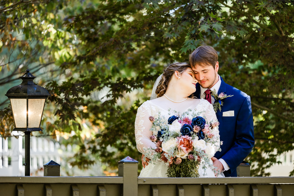 Bride leaning back into her groom's chest, eyes closed.