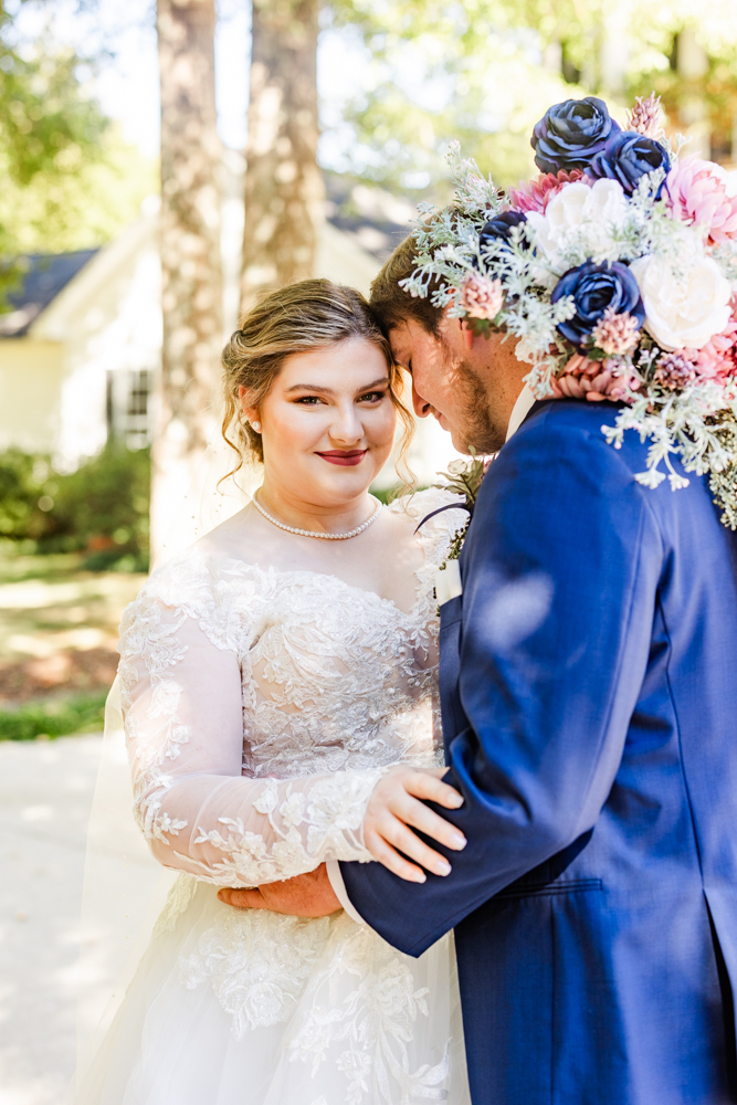 Groom embracing his soon-to-be wife during bride and groom portraits at their Huntsville, AL wedding.