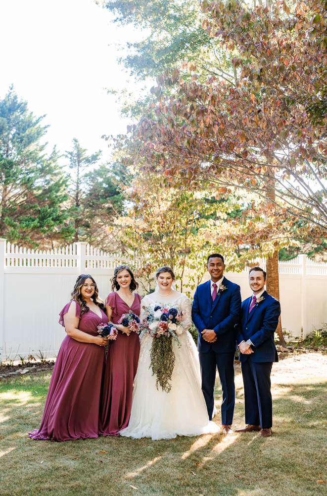 Bride with her two bridesmaids and two bridesmen by her side. 