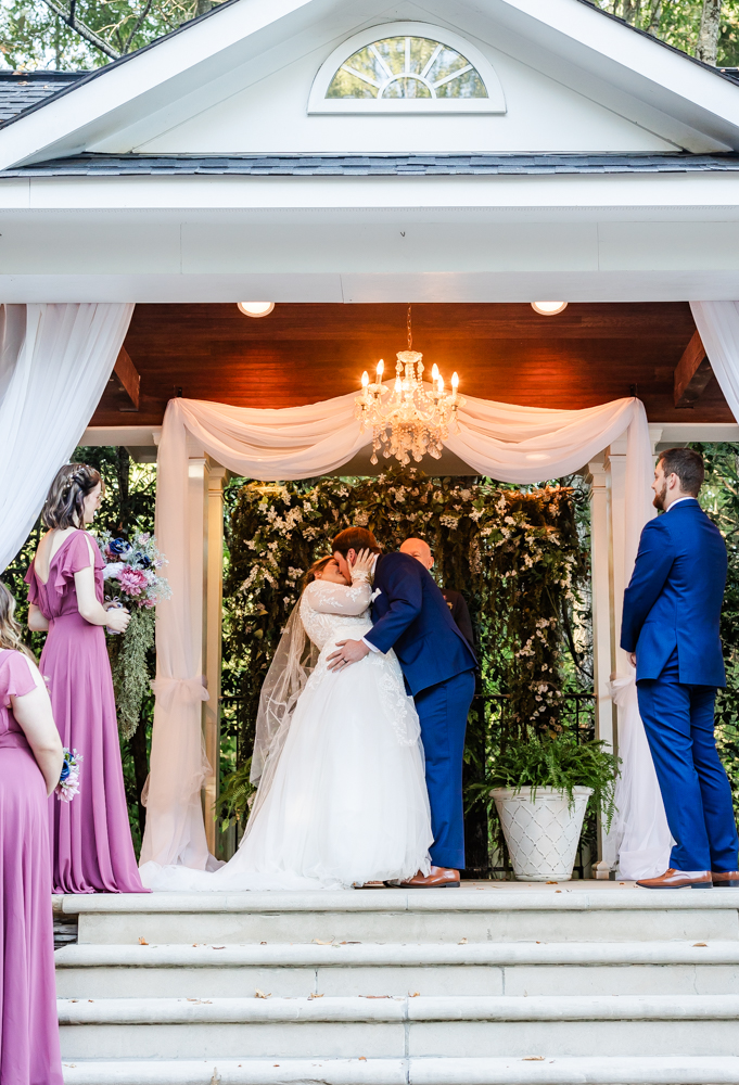 Bride and groom sharing their first kiss as husband and wife at Annabella at Cedar Glen in Huntsville 