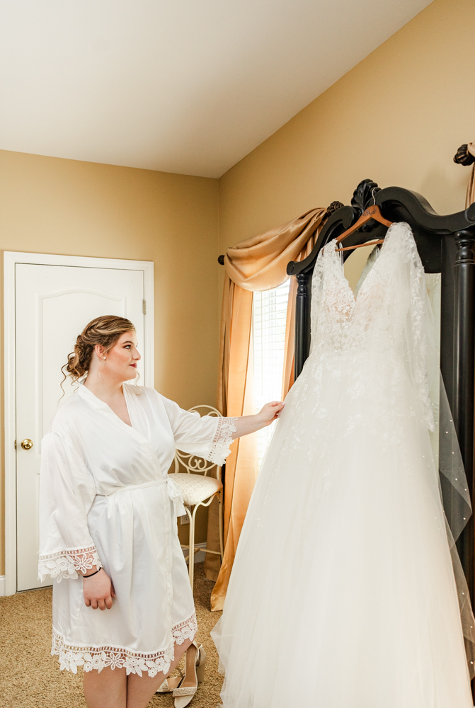 Bride admiring her wedding dress in the bridal suite at Annabella at Cedar Glen.