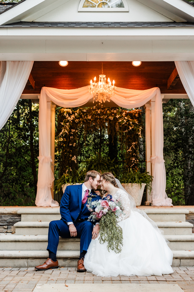 Newlywed portraits in the outdoor ceremony space of a Huntsville wedding venue.