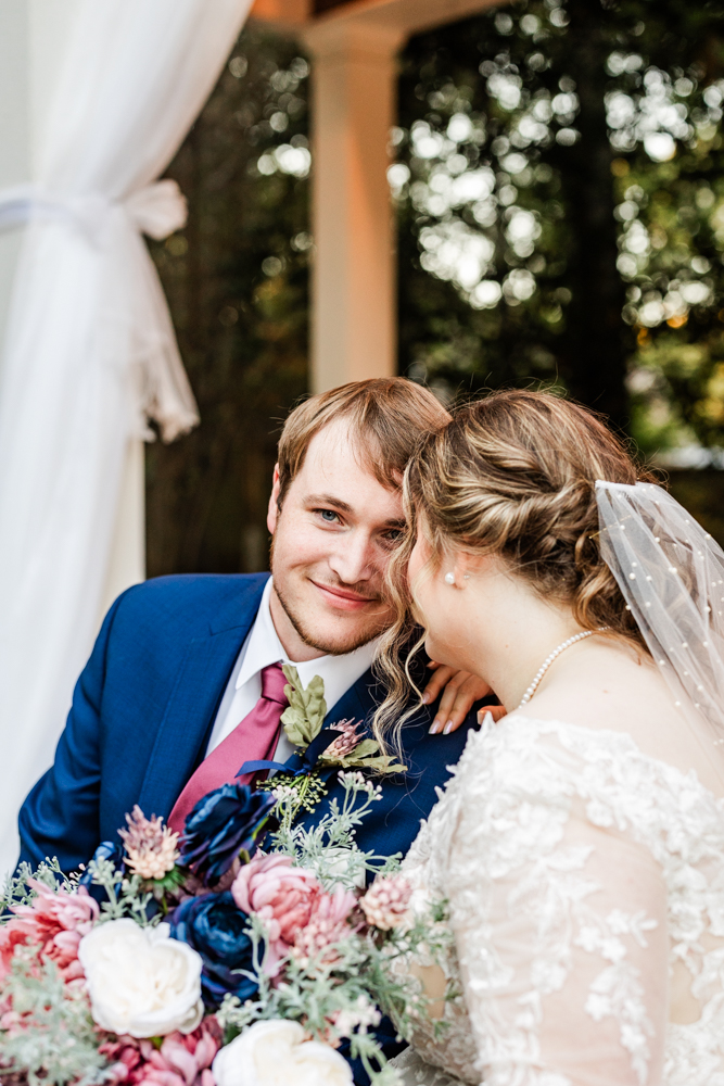 Newlywed portraits in the outdoor ceremony space of a Huntsville wedding venue.