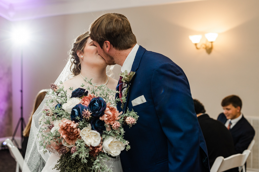 Newlywed couple kissing at their Huntsville wedding reception at Annabella at Cedar Glen