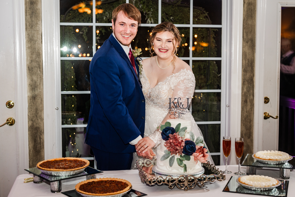 Couple cutting the cake during their Huntsville wedding reception at Annabella at Cedar Glen