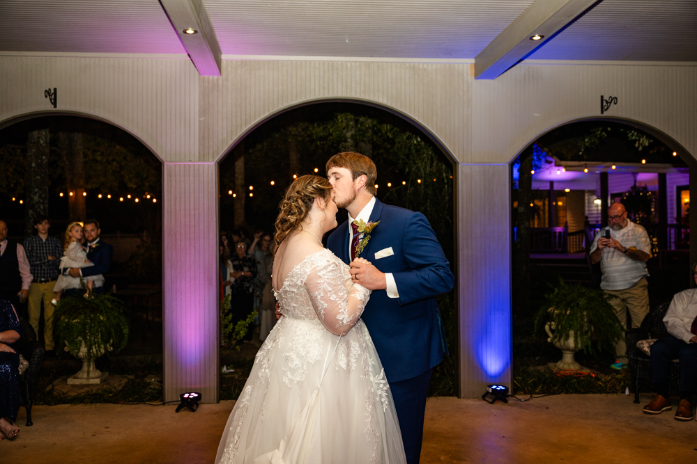 Man kisses woman on the forehead as they share their first dance as husband and wife at a wedding venue in Huntsville, AL