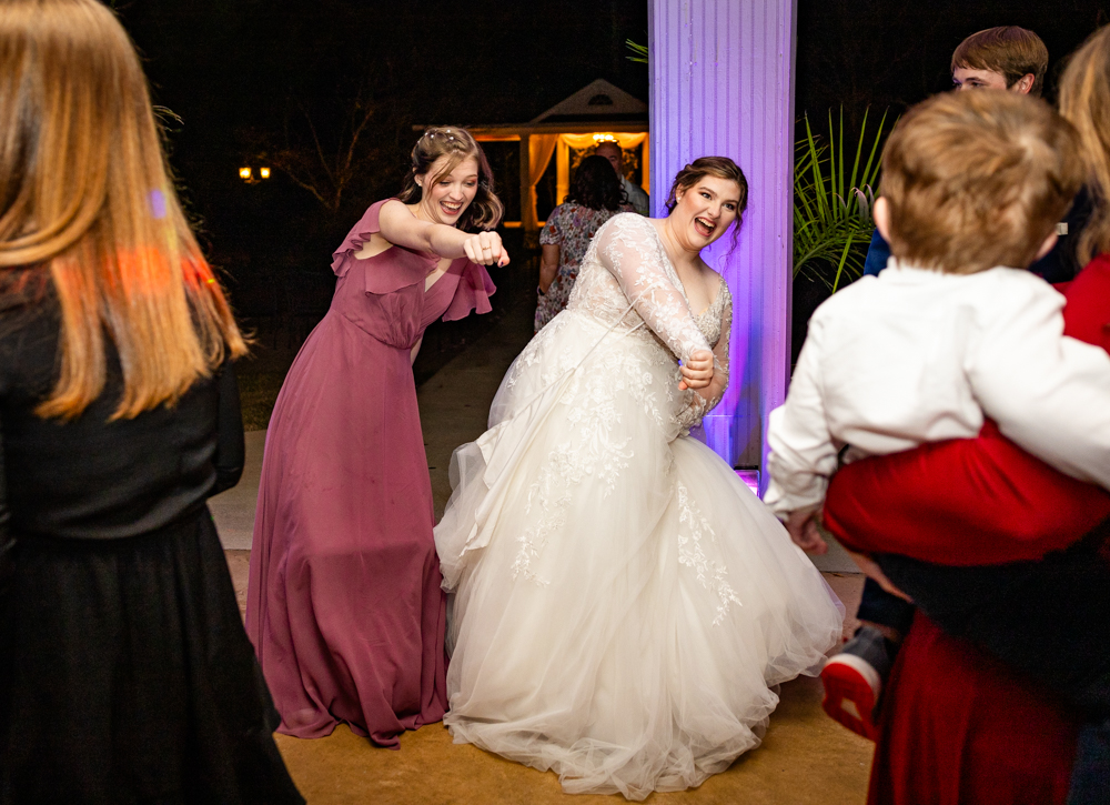 Bride and her sister/bridesmaid dancing during a Huntsville wedding reception.