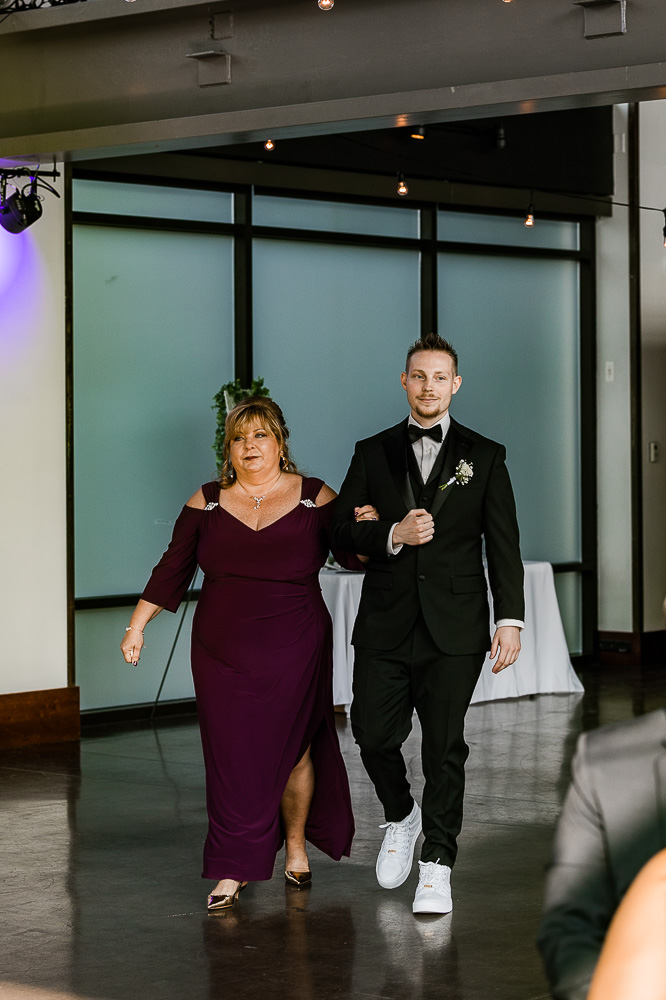 The Bridge Building wedding ceremony groom and his mom walking down the aisle