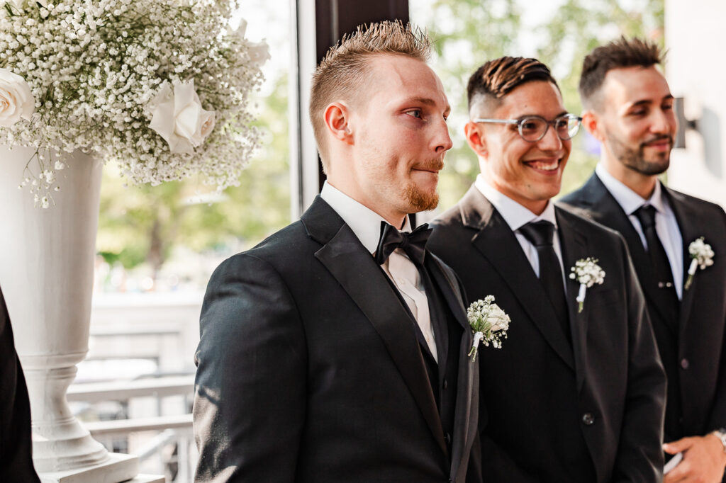 The Bridge Building groom's face while the bride walks down the aisle