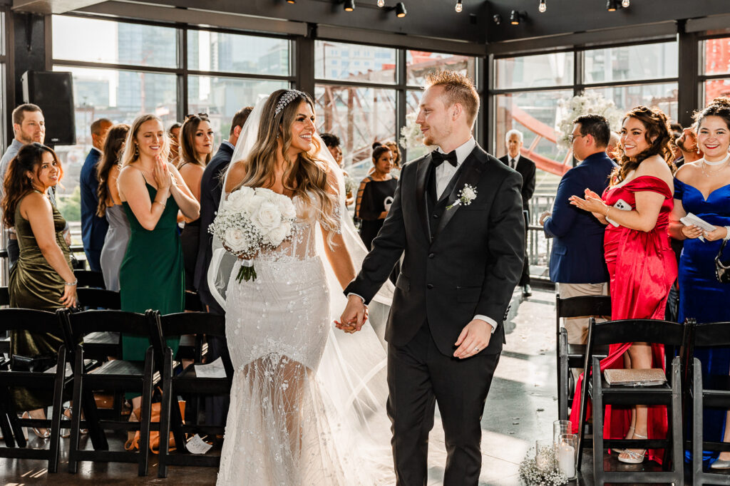 The Bridge Building bride and groom walking back down the aisle after saying their vows