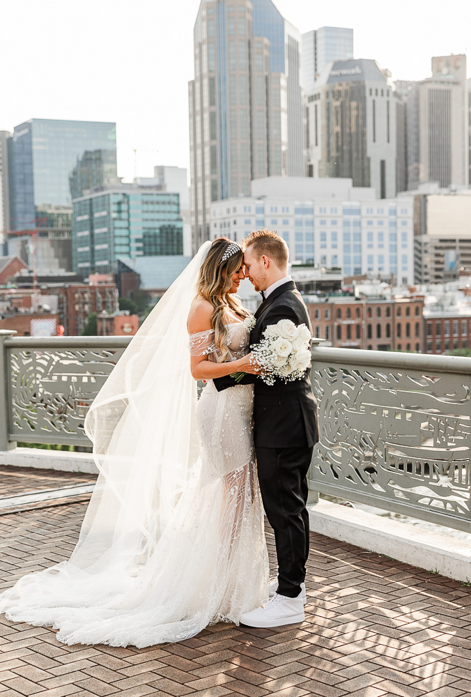 The Bridge Building bride and groom embracing each other forehead to forehead