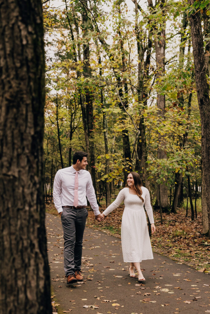 Engaged couple walking hand in hand at Long Hunter State Park