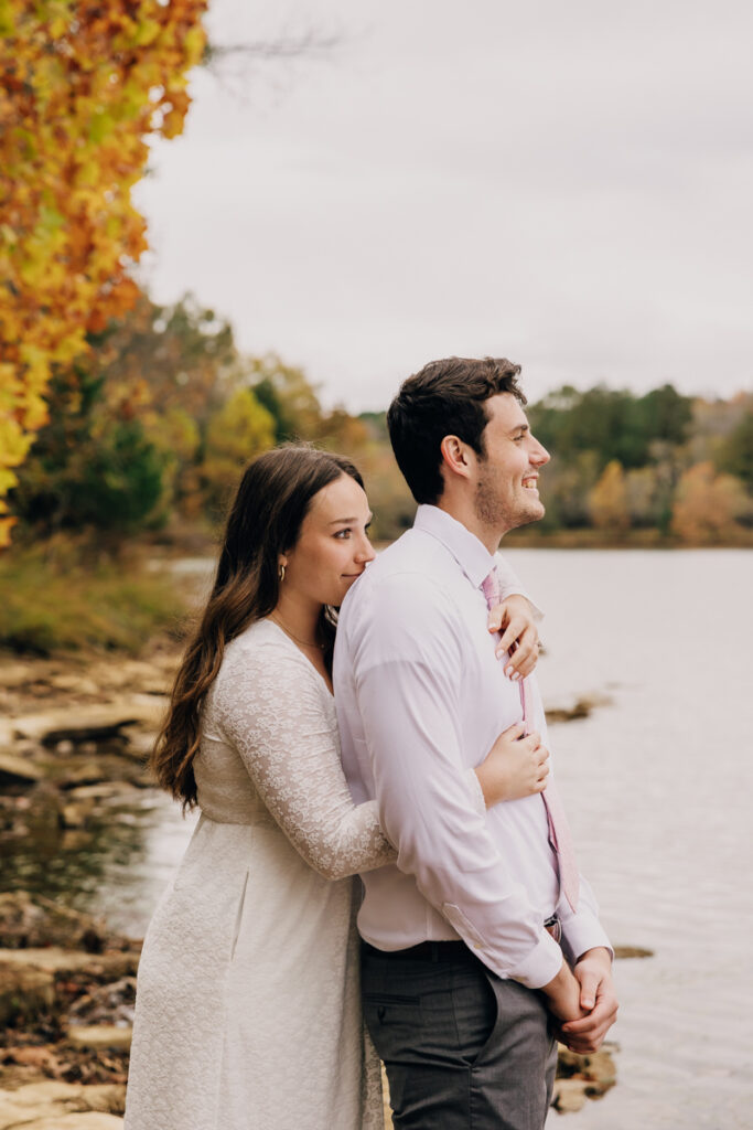 Engaged couple gazing off into the distance during their engagement session at Long Hunter State Park