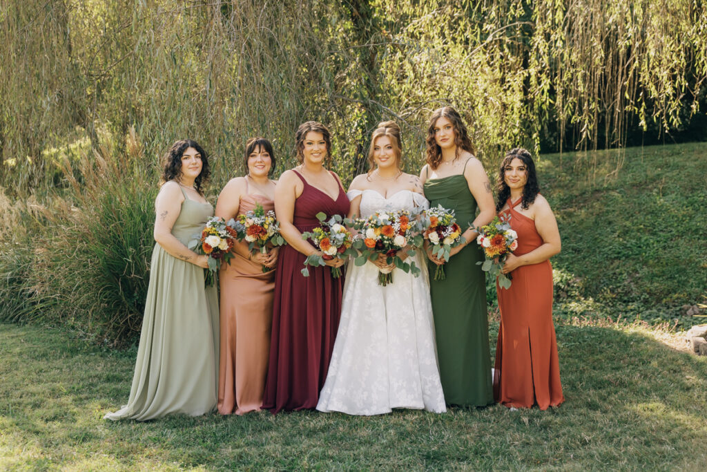 Bride with bridesmaids at Rustic Elegance Event Center