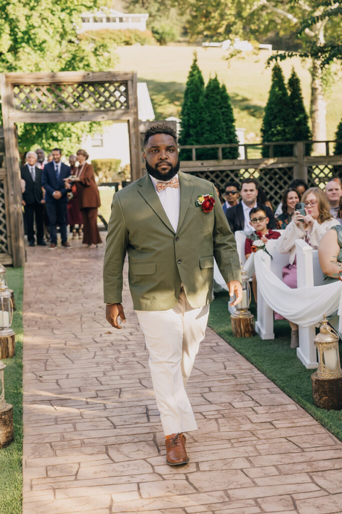 Groom walking down the aisle at Rustic Elegance Event Center