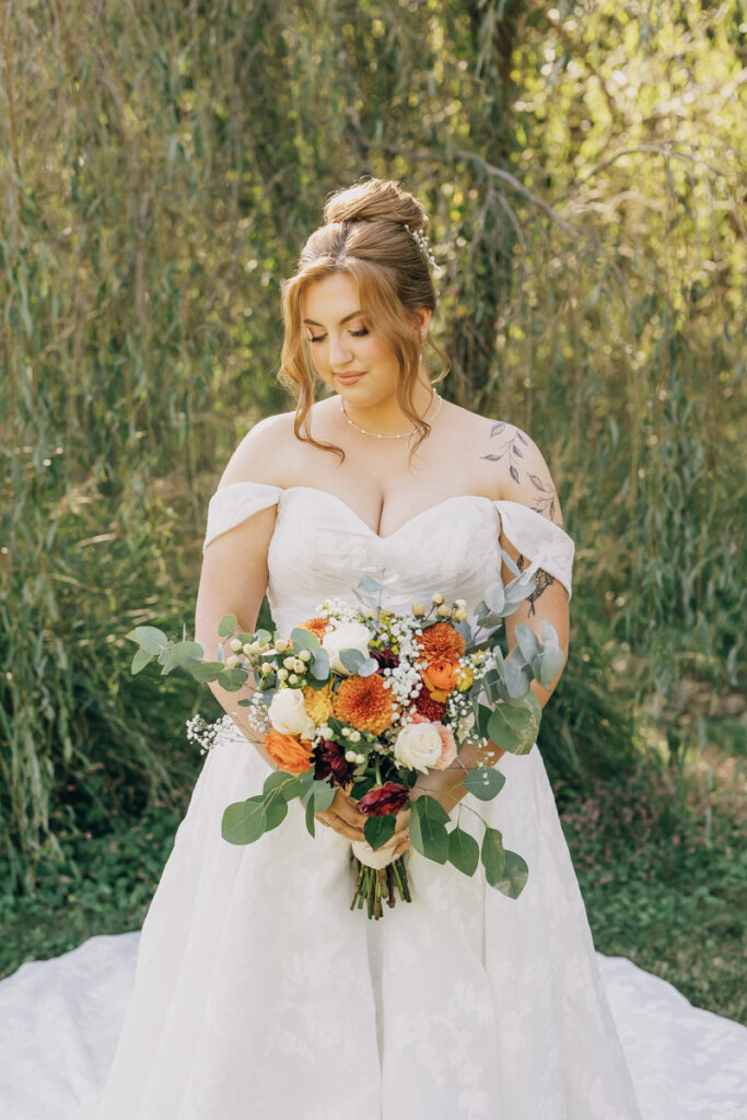 Bride gazing down at her florals