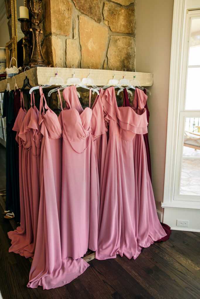 Bridesmaids’ dresses hanging from the fireplace mantel in the bridal suite.