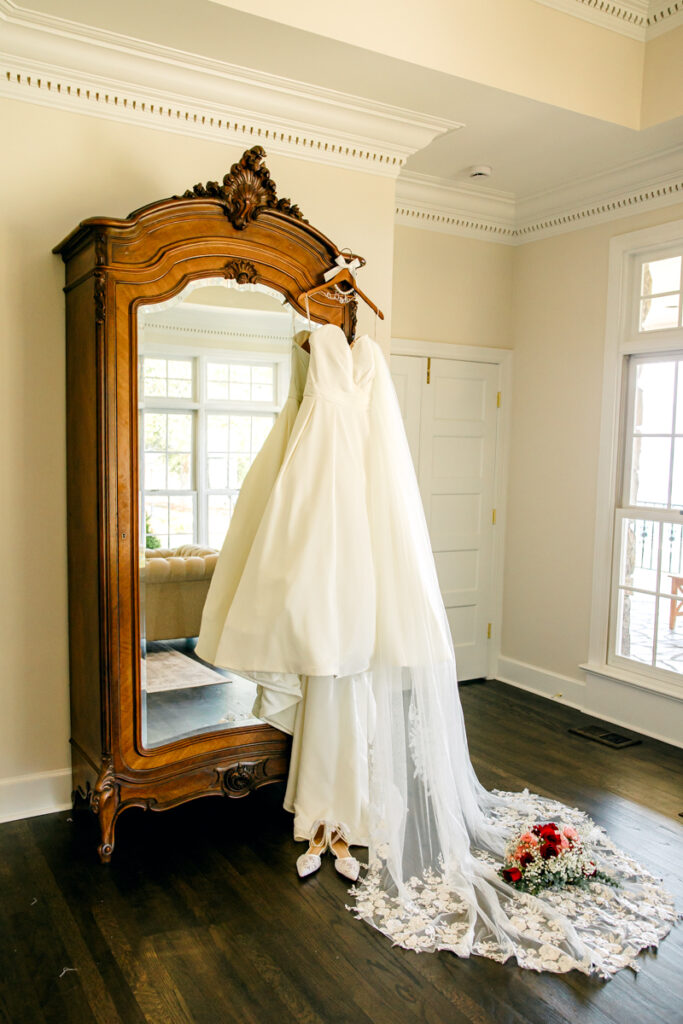 Wedding dress and veil hanging in the getting ready suite at Stone Haven in Section, Alabama.