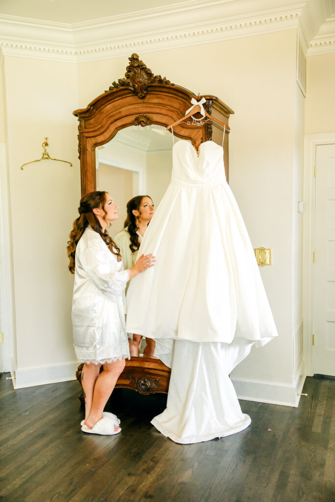 Bride quietly admiring her wedding dress before putting it on.