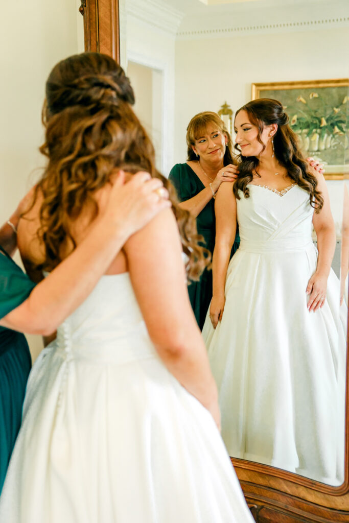 Bride and her mom embracing after she puts on her wedding dress at Stone Haven wedding venue.