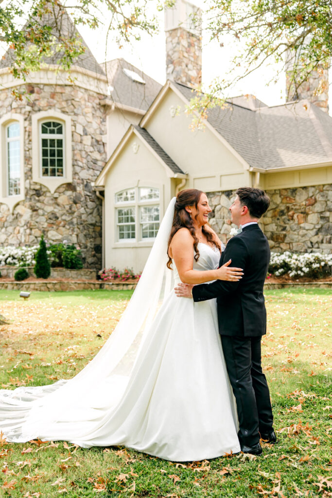 Bride and groom embracing after their first look at Stone Haven in Section, AL
