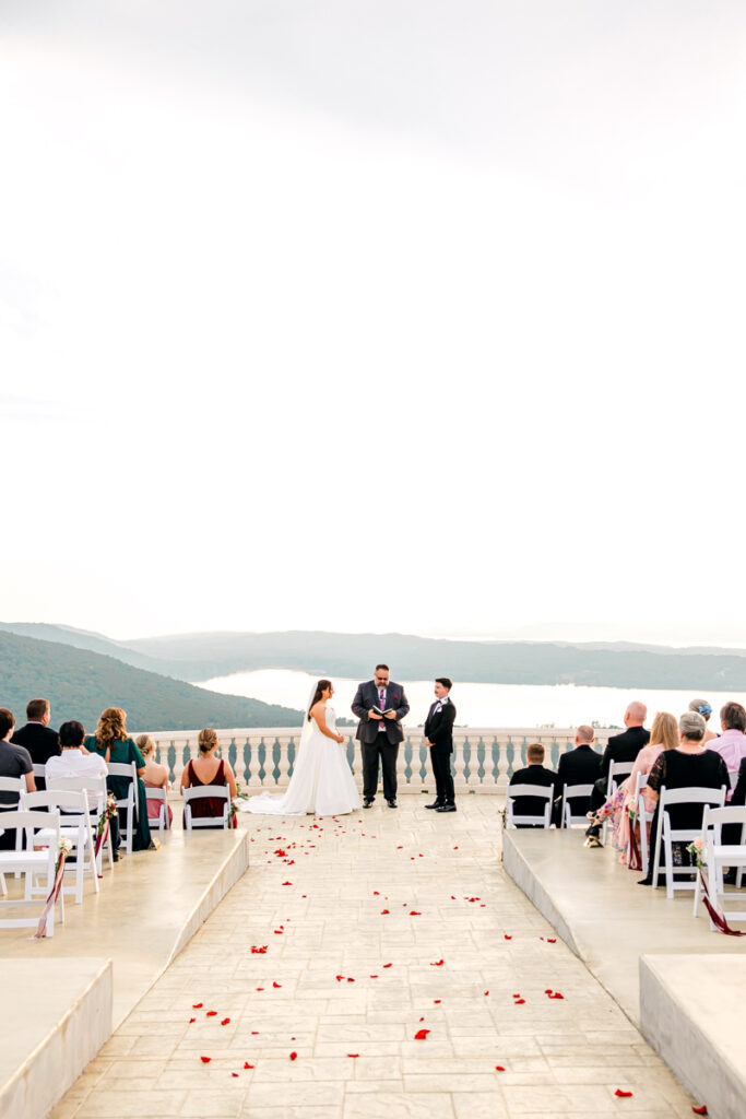 Wedding ceremony under cloudy skies on the outdoor patio at Stone Haven.