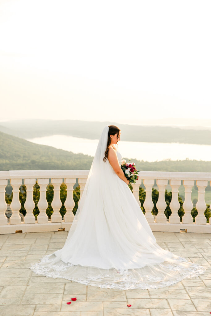 Bride gazing down at her flowers.
