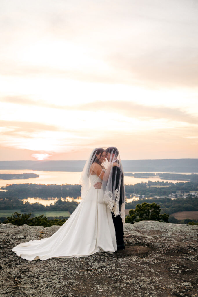 Bride and groom sharing a moment underneath the bride’s veil.