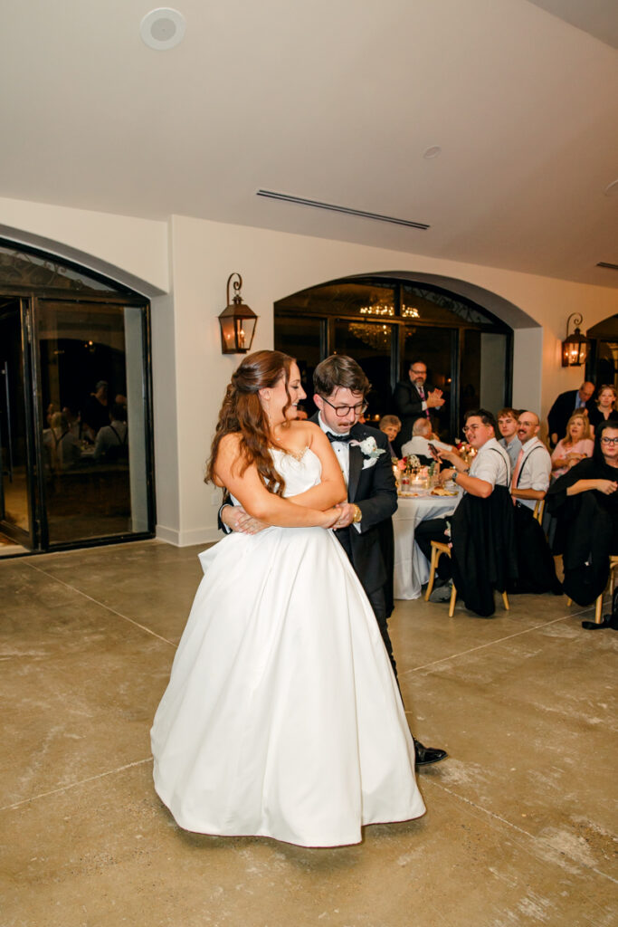 Bride and groom dancing during their reception in the Grand Hall at Stone Haven.