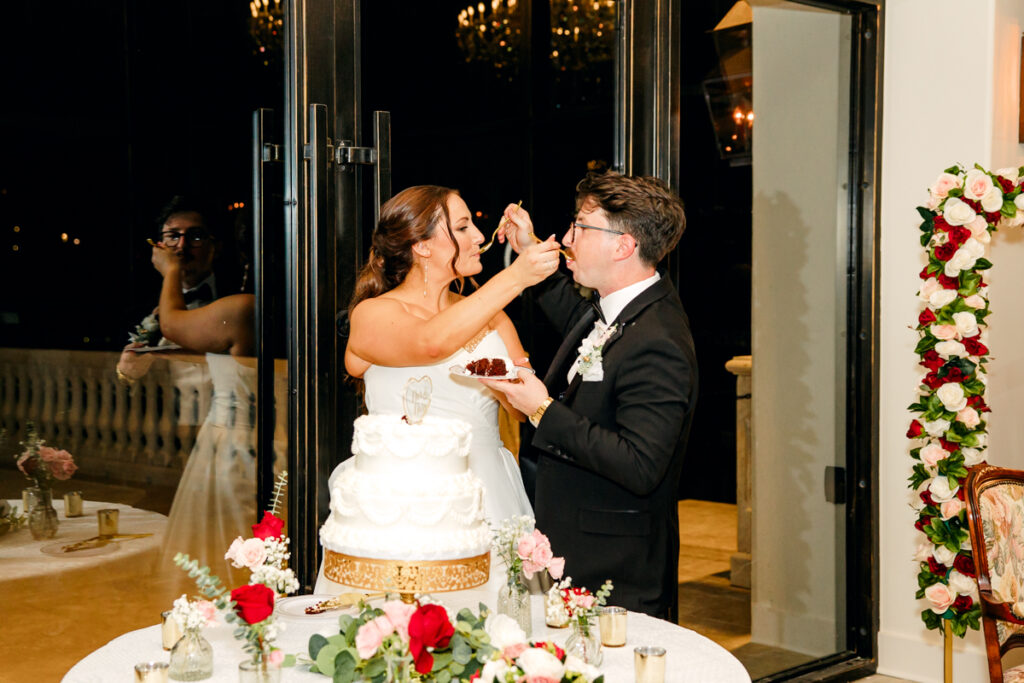 Bride and groom tasting their wedding cake.