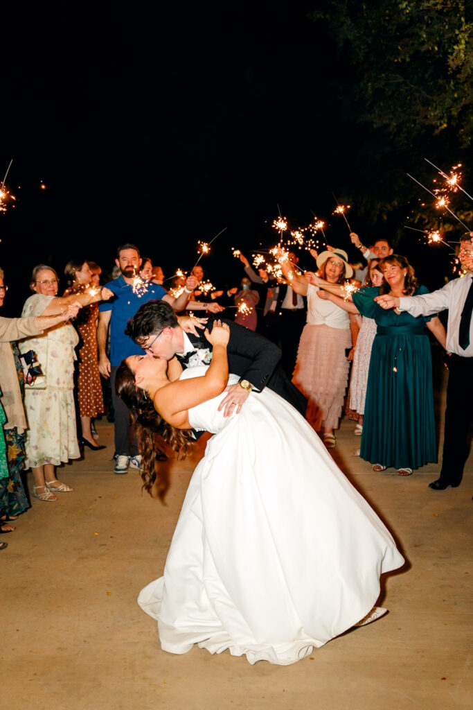 Groom dipping his bride during their sparkler exit at Stone Haven in Alabama.