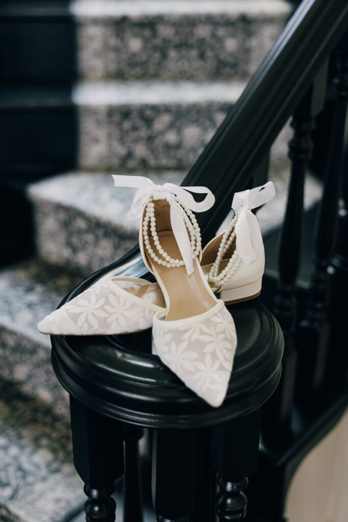Shoes sitting on the staircase banister at Stone Haven Wedding Venue