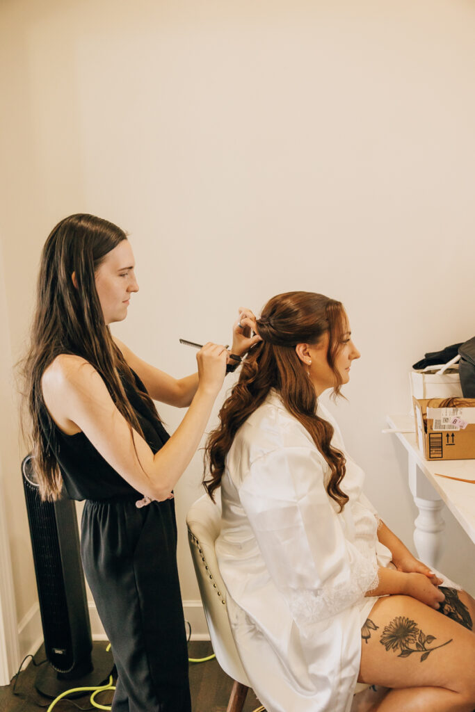 Bride getting her hair done inside the French-inspired Rock House at Stone Haven wedding venue.