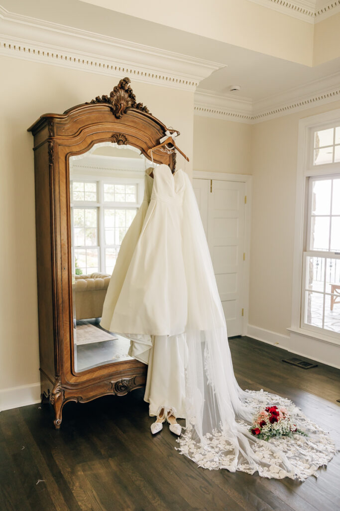 Wedding dress and veil hanging in the getting ready suite at Stone Haven in Section, Alabama.