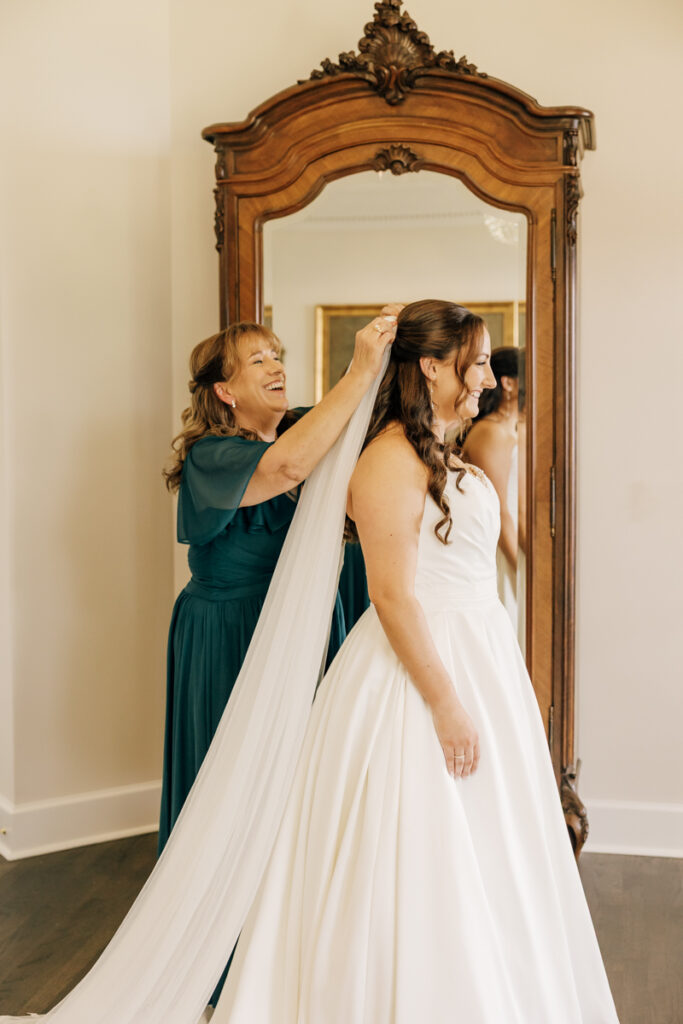 Bride getting her veil adjusted by her mother at Stone Haven wedding venue