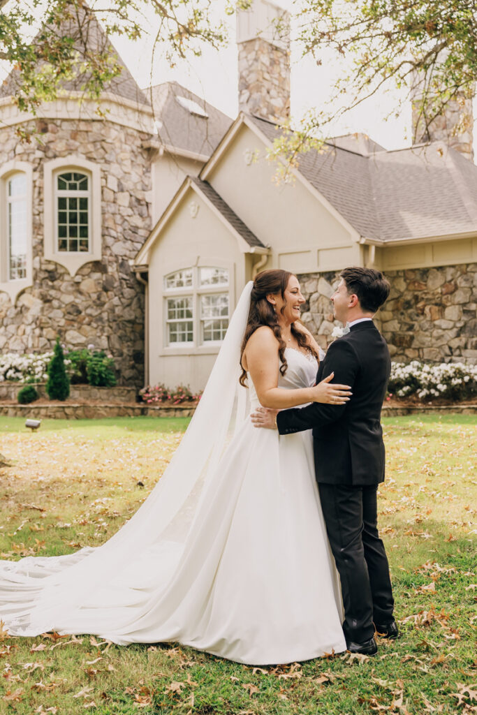 Bride and groom embracing after their first look at Stone Haven in Section, AL