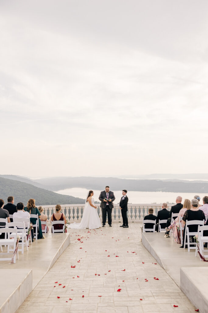 Wedding ceremony under cloudy skies on the outdoor patio at Stone Haven.