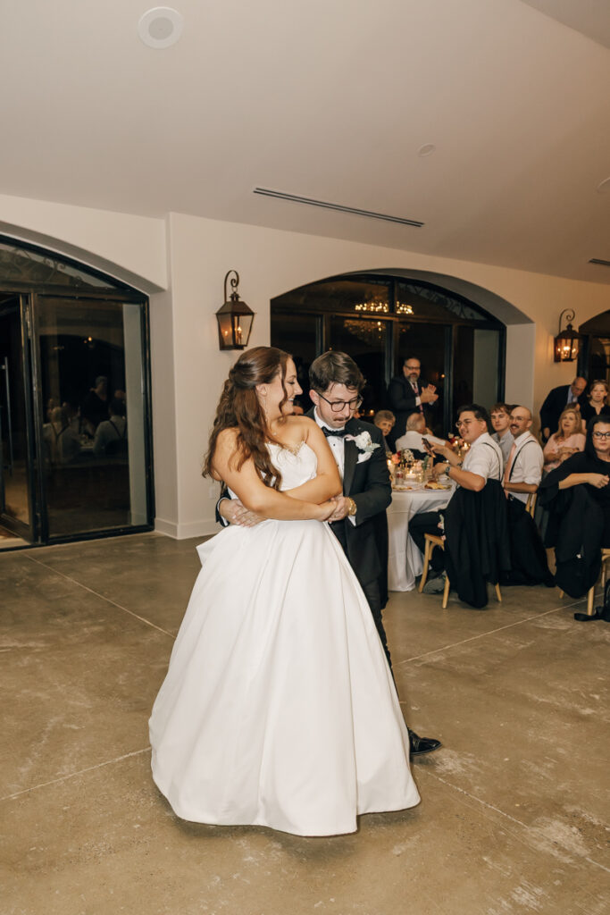 Bride and groom dancing during their reception in the Grand Hall at Stone Haven.