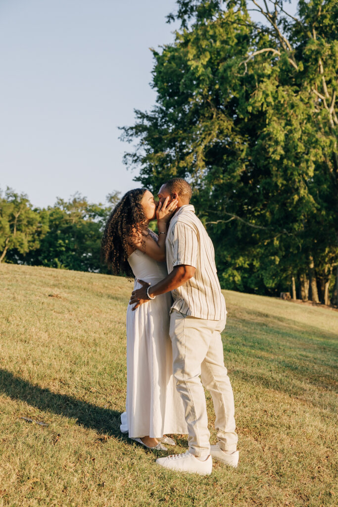 Couple sharing a kiss after the Arrington Vineyards surprise proposal