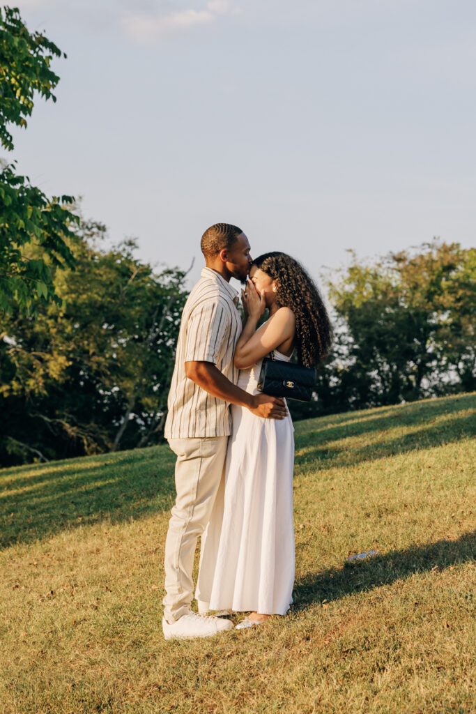 Man kissing his new fiancée on the forehead after their Arrington Vineyards surprise proposal