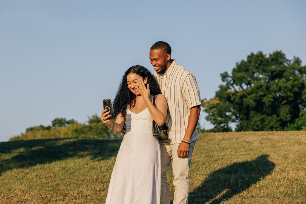 Couple FaceTiming family after engagement at Arrington Vineyards