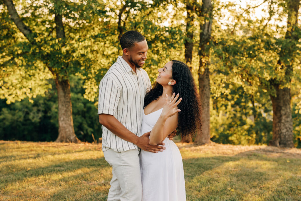 Jennifer showing off engagement ring while embracing Christian