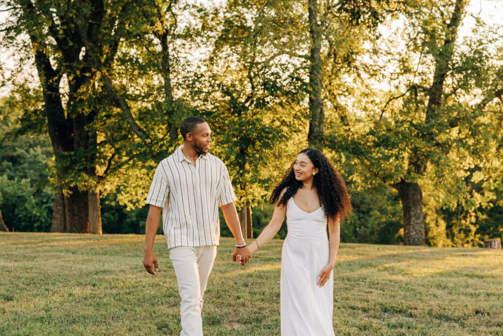Bride and groom-to-be holding hands and enjoying their new engagement