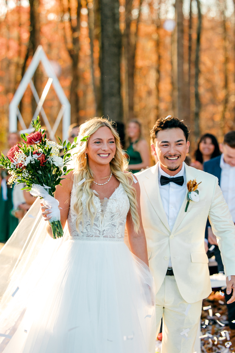 Bride and groom exiting their ceremony at Hickory Meadow in Charlotte, TN