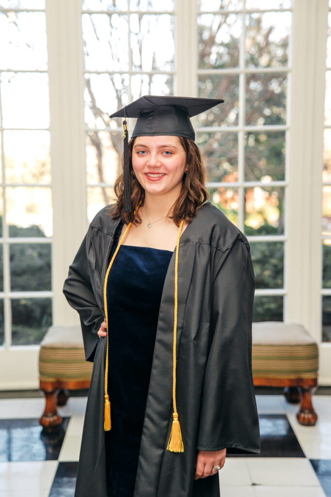 Nashville senior photography with senior smiling in cap and gown at Belmont University.
