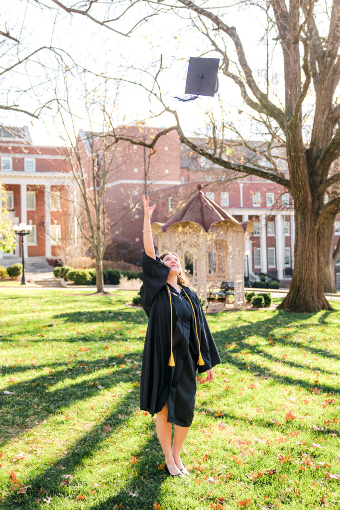 Senior tossing cap on Belmont University lawn.